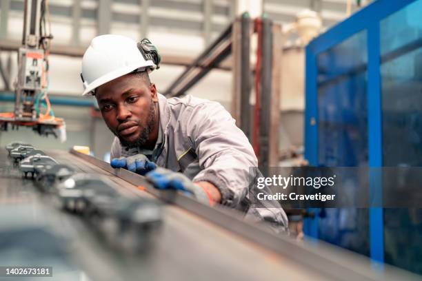 quality engineer working in the automotive industry while checking the quality of components of automotive parts in the production line. quality assurance makes them the best performance quality control concepts. - 20s talking serious bildbanksfoton och bilder