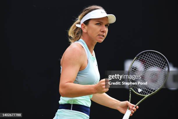 Simona Halep of Romania celebrates winning the first set in their Women's Singles First Round match against Lesia Tsurenko of Ukraine during Day...