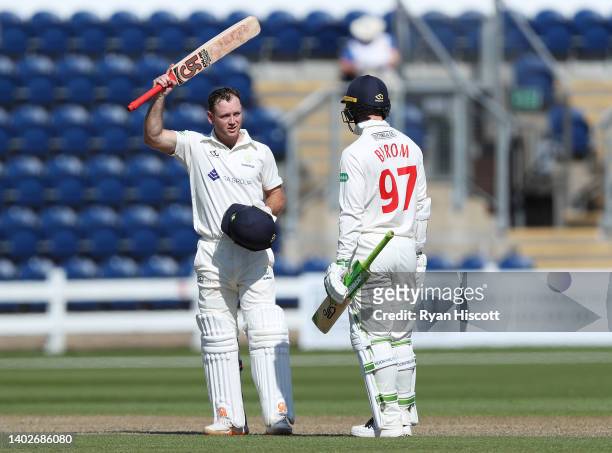 Colin Ingram of Glamorgan celebrates after scoring a century as teammate Eddie Byrom looks on during the LV= Insurance County Championship match...