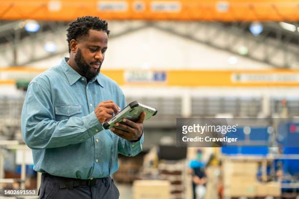 production engineer using tablet and working in the factory. he checked the facility overall items of production line and quantity before sent them to server for collect data in the next  in the plastic industry factory. - inventory accuracy stock pictures, royalty-free photos & images