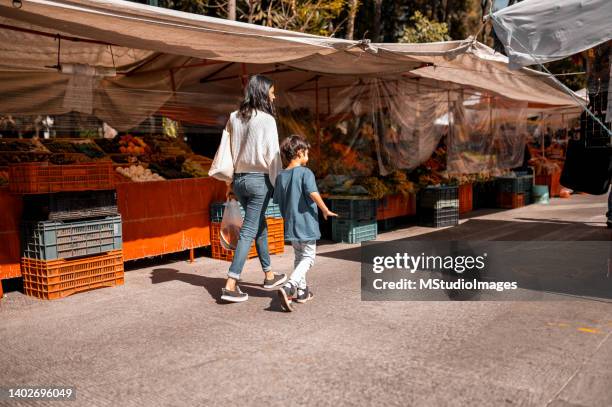mother and son at the street market - mexican street market stock pictures, royalty-free photos & images