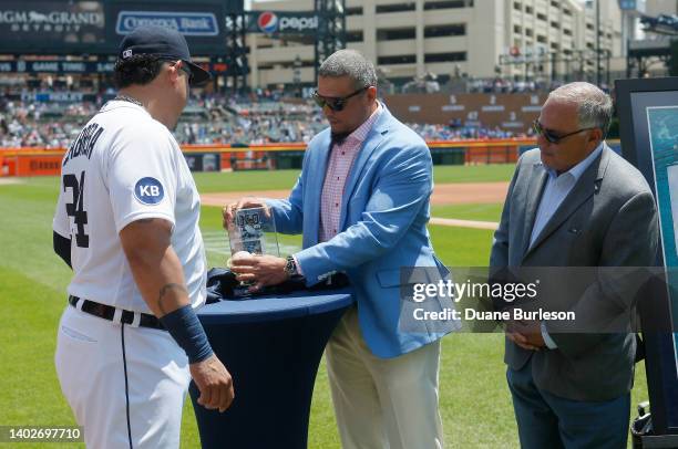 Miguel Cabrera of the Detroit Tigers is presented with his 3,000th hit baseball by former Tiger Victor Martinez and Al Avila, Executive Vice...