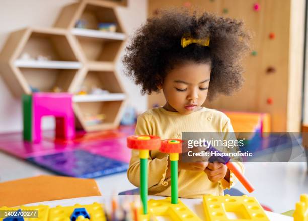 african american girl playing with building blocks at the school - children playing with toys imagens e fotografias de stock