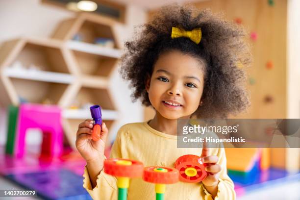 beautiful girl playing with building blocks at the school - preschool age stockfoto's en -beelden