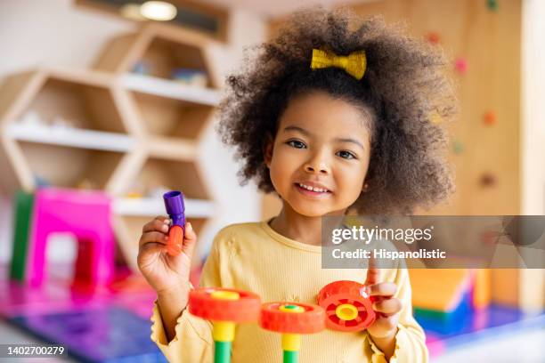 beautiful girl playing with building blocks at the school - förskoleåldern bildbanksfoton och bilder
