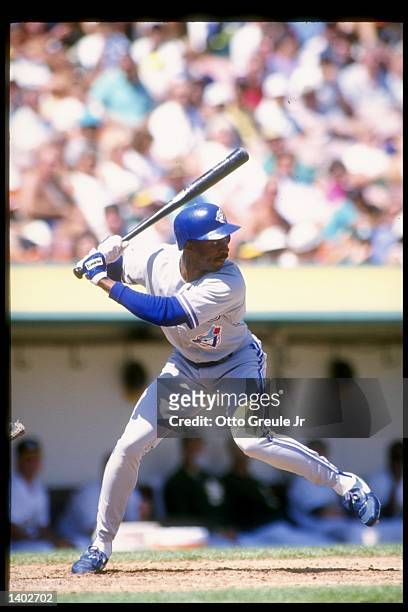 Devon White of the Toronto Blue Jays swings at the ball during a game against the Oakland Athletics at the Oakland Coliseum in Oakland, Califoria....