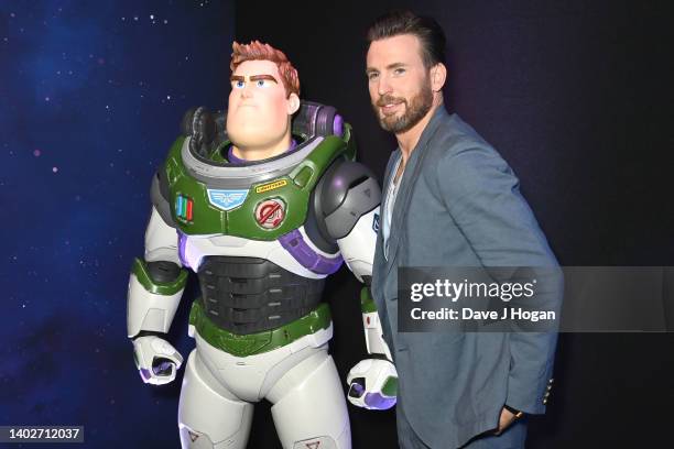Chris Evans poses with a Buzz Lightyear character during the Lightyear UK Premiere at Cineworld Leicester Square on June 13, 2022 in London, England.