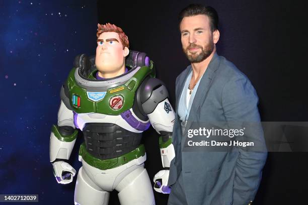 Chris Evans poses with a Buzz Lightyear character during the Lightyear UK Premiere at Cineworld Leicester Square on June 13, 2022 in London, England.