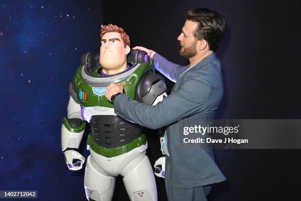 Chris Evans poses with a Buzz Lightyear character during the Lightyear UK Premiere at Cineworld Leicester Square on June 13, 2022 in London, England.