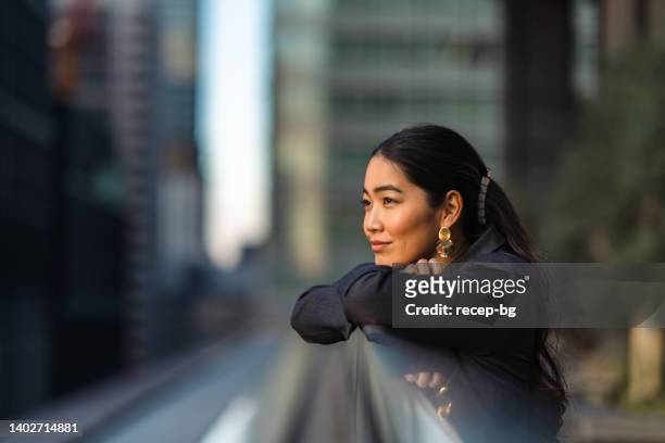 portrait of beautiful businesswoman in city - aspirations stock pictures, royalty-free photos & images