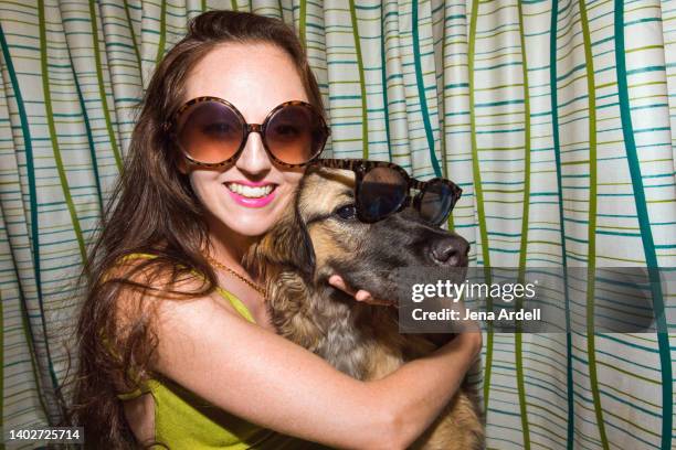 woman with dog wearing sunglasses, funny young woman with dog candid portrait - sunglasses and puppies stock pictures, royalty-free photos & images