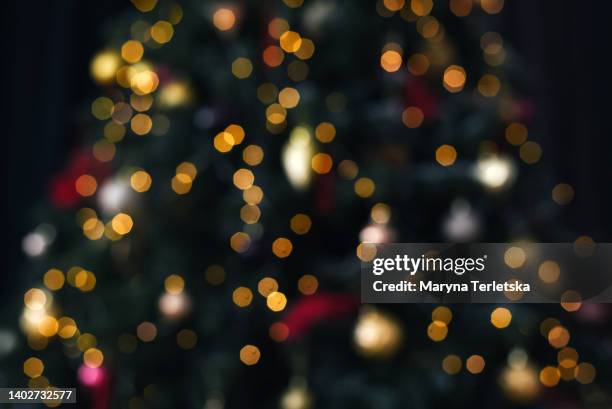 blurred defocus christmas background. blurred dark background with christmas tree. new year. christmas. christmas decor. christmas tree. christmas background. holiday. - christmas bokeh ストックフォトと画像