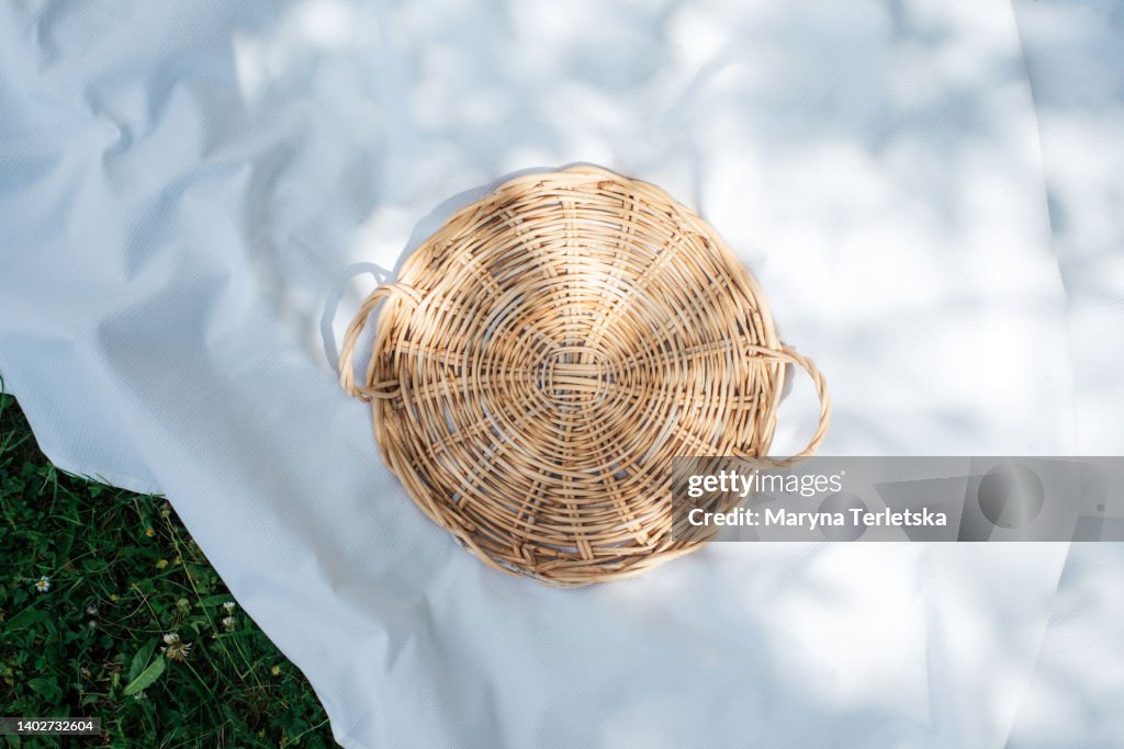 Wicker tray. Food mockup. Picnic. Background for picnic, food, text and any inscription. Straw lining. Boho style. Ecological crockery and decorative elements.