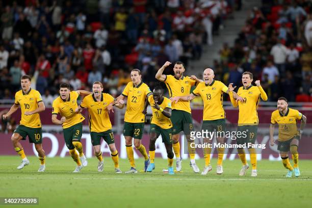 Players of Australia celebrate their sides victory after a penalty shoot out following the 2022 FIFA World Cup Playoff match between Australia...