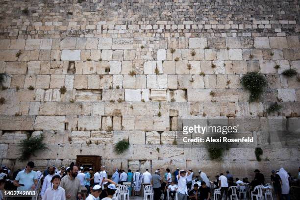 Jewish worshipers pray at the Western Wall in the Old City on June 13, 2022 in Jerusalem, Israel. On April 24th, Israel removed all COVID-19...