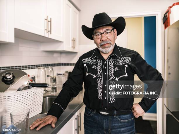 mature latin man dressed as mexican cowboy having a coffee - western shirt stock pictures, royalty-free photos & images