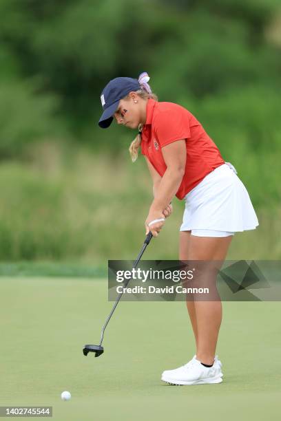 Jensen Castle of The United States Team plays hits a putt on the 16th hole in her match against Hannah Darling during the singles matches on day...