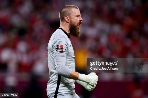 Andrew Redmayne of Australia reacts after saving a penalty shootout goal in the 2022 FIFA World Cup Playoff match between Australia Socceroos and...