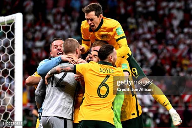 Australia celebrate after defeating Peru in the 2022 FIFA World Cup Playoff match between Australia Socceroos and Peru at Ahmad Bin Ali Stadium on...