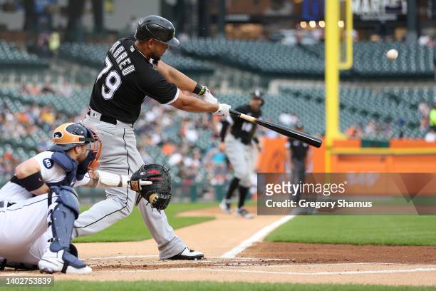 Jose Abreu of the Chicago White Sox hits a two run first inning home run in front of Tucker Barnhart of the Detroit Tigers at Comerica Park on June...
