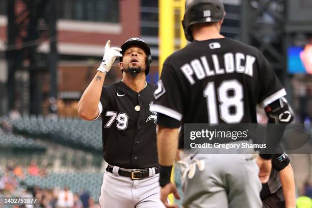 Jose Abreu of the Chicago White Sox celebrates his two run first inning home run in behind AJ Pollock while playing the Detroit Tigers at Comerica...