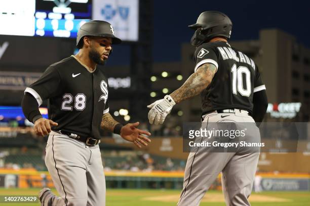 Leury Garcia of the Chicago White Sox celebrates scoring a run in the sixth inning with Yoan Moncada while playing the Detroit Tigers at Comerica...