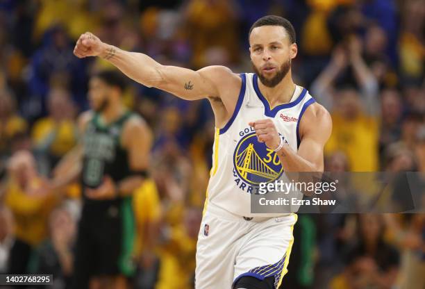 Stephen Curry of the Golden State Warriors celebrates after teammate Andrew Wiggins made a basket and drew a foul during the second quarter against...