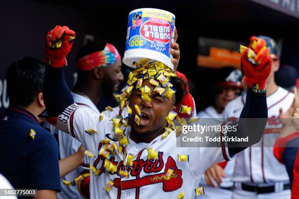 Ozzie Albies of the Atlanta Braves reacts as he has a bucket of dubble bubble gum dumped on his head following a grand slam during the seventh inning...