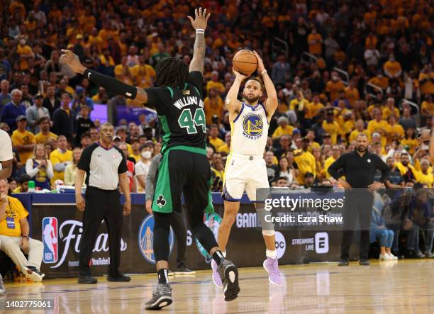 Stephen Curry of the Golden State Warriors shoots a three point basket against Robert Williams III of the Boston Celtics during the fourth quarter in...