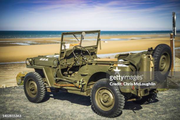 world war 2 jeep omaha beach on the normandy coast in france - jeep stock pictures, royalty-free photos & images