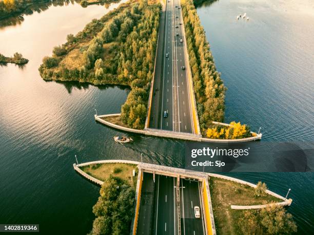 aquaduct veluwemeer in the veluwe lake with a boat sailing in the canal - veluwe stock pictures, royalty-free photos & images