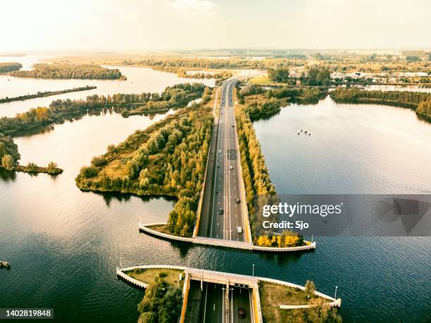 aquaduct veluwemeer in the veluwe lake with a boat sailing in the canal - veluwemeer stockfoto's en -beelden