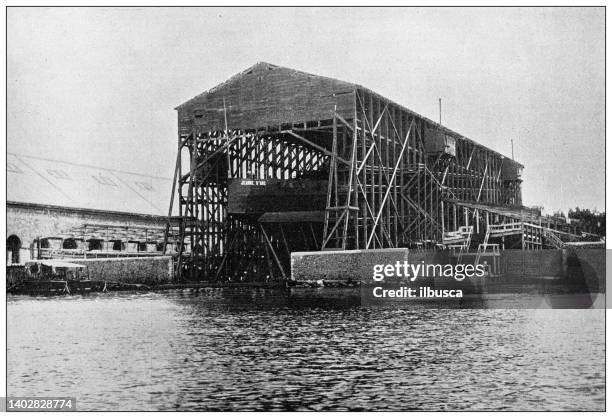 antique photo: cruiser shipyard - ship construction stock illustrations