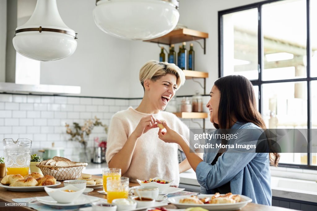 Happy Young Couple Having Breakfast at Home