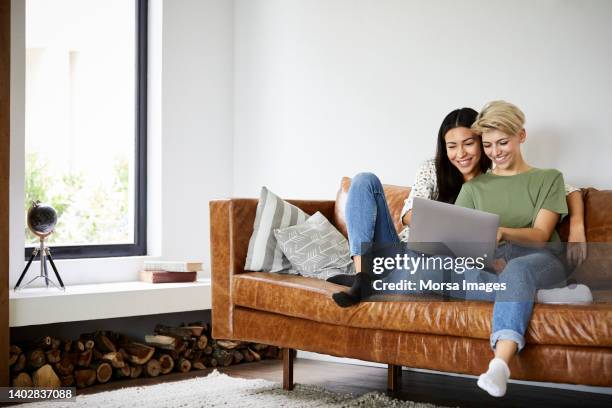 couple watching movie on laptop - happy couple at home stock pictures, royalty-free photos & images