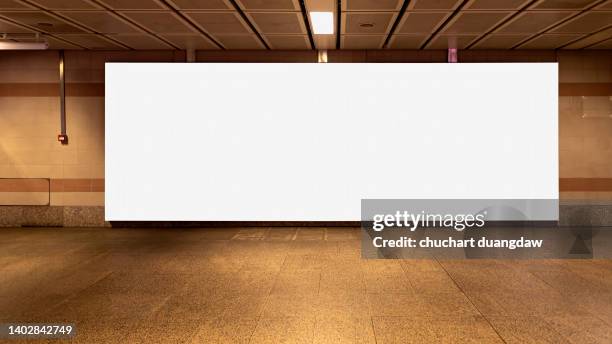 blank billboard advertising banner media display on a subway station wall - poster subway stock-fotos und bilder