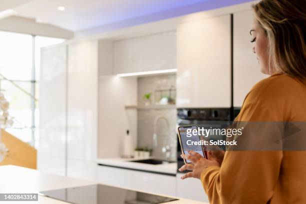 smart phone thermostat - smart kitchen stock pictures, royalty-free photos & images
