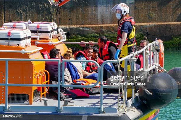 Migrants who attempted the crossing of the English Channel from France arrive at Dover on board a lifeboat on June 14, 2022 in Dover, England. The...