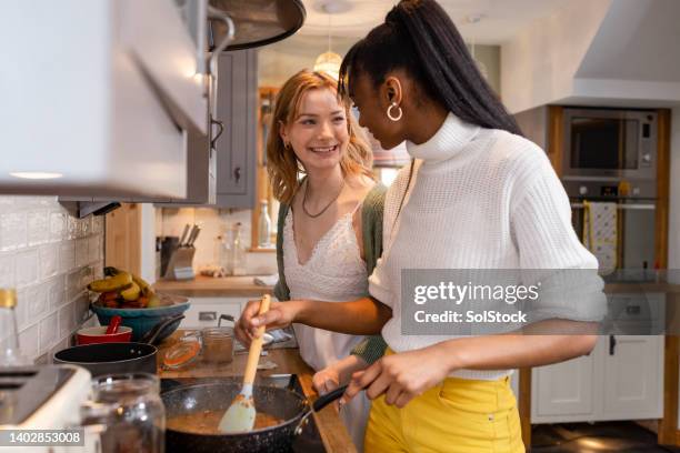 making a tasty curry - only young women stock pictures, royalty-free photos & images