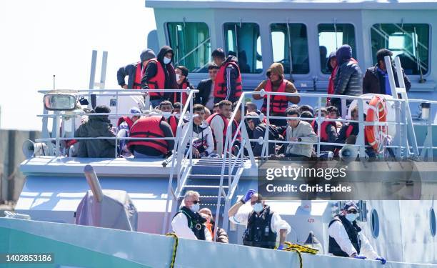 Large number of Migrants, including many women and children, arrive in port on Border Force boat Valiant after attempting the crossing of the English...