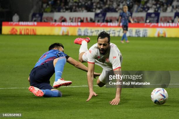 Taha Yassine Khenissi of Tunisia is fouled by Maya Yoshida of Japan resulting in a penalty kick during the international friendly match between Japan...