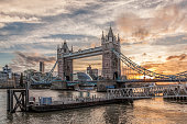 Tower Bridge against colorful sunset with pier in London, England, UK