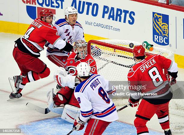 Goaltender Cam Ward of the Carolina Hurricanes watches as the puck bounces over the net during play against the New York Rangers at the RBC Center on...