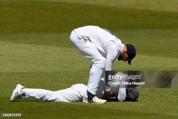 Adam Lyth of Yorkshire is helped to his feet by team mate Will Fraine after spilling a chance at slip during the LV= Insurance County Championship...