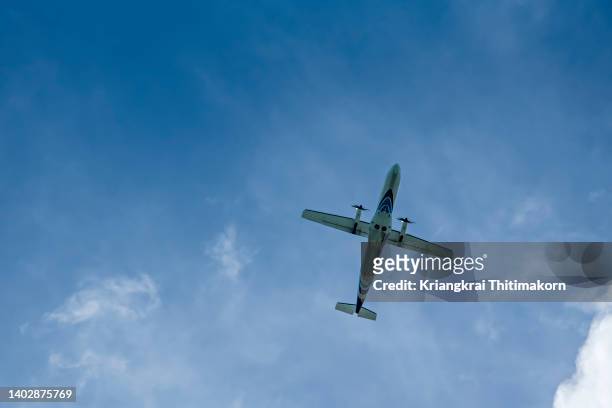 an propeller airplane is flying in the sky. - higher return stock pictures, royalty-free photos & images
