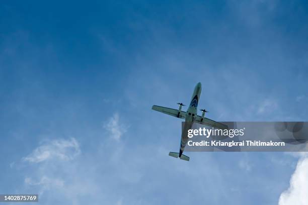 an propeller airplane is flying in the sky. - small jet stock pictures, royalty-free photos & images