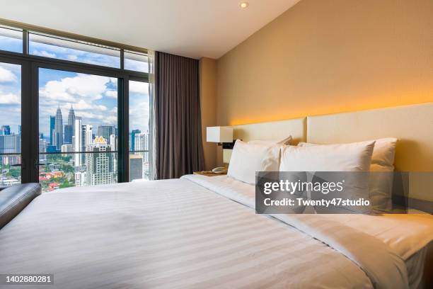 interior of the bedroom in luxury hotel - hotelroom stockfoto's en -beelden