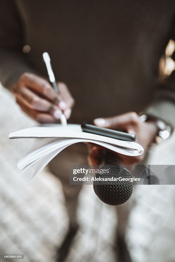 African Male Journalist Writing Questions For Press Conference