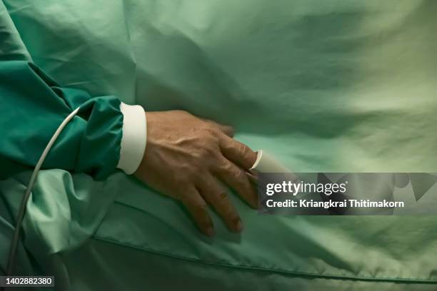 an oxygen measure is attached to a hand of patient during operation. - sleep hygiene stock pictures, royalty-free photos & images