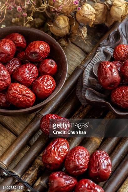 dried red jujube on the bamboo table - red plum stock pictures, royalty-free photos & images